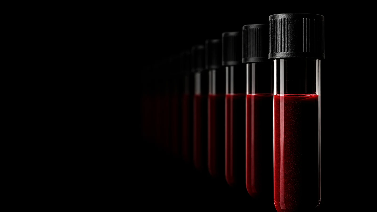 A receding row of glass blood-collection vials fading into black — a specimen series across time.